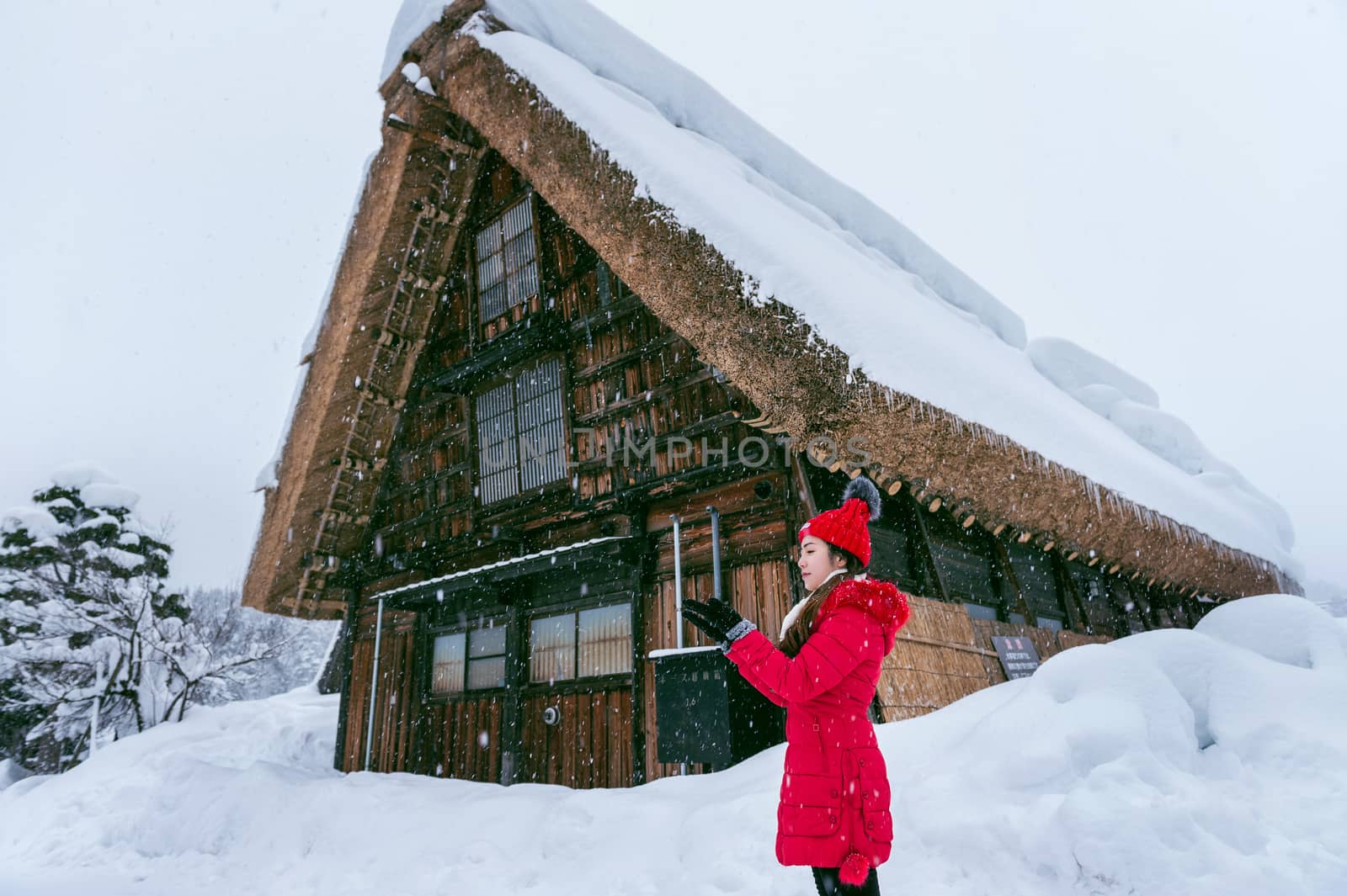 Young woman in Shirakawa-go village in winter, UNESCO world heritage sites, Japan.