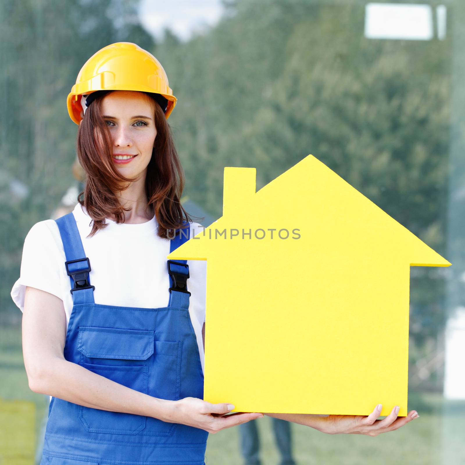 Forewoman presenting house symbol, construction concept