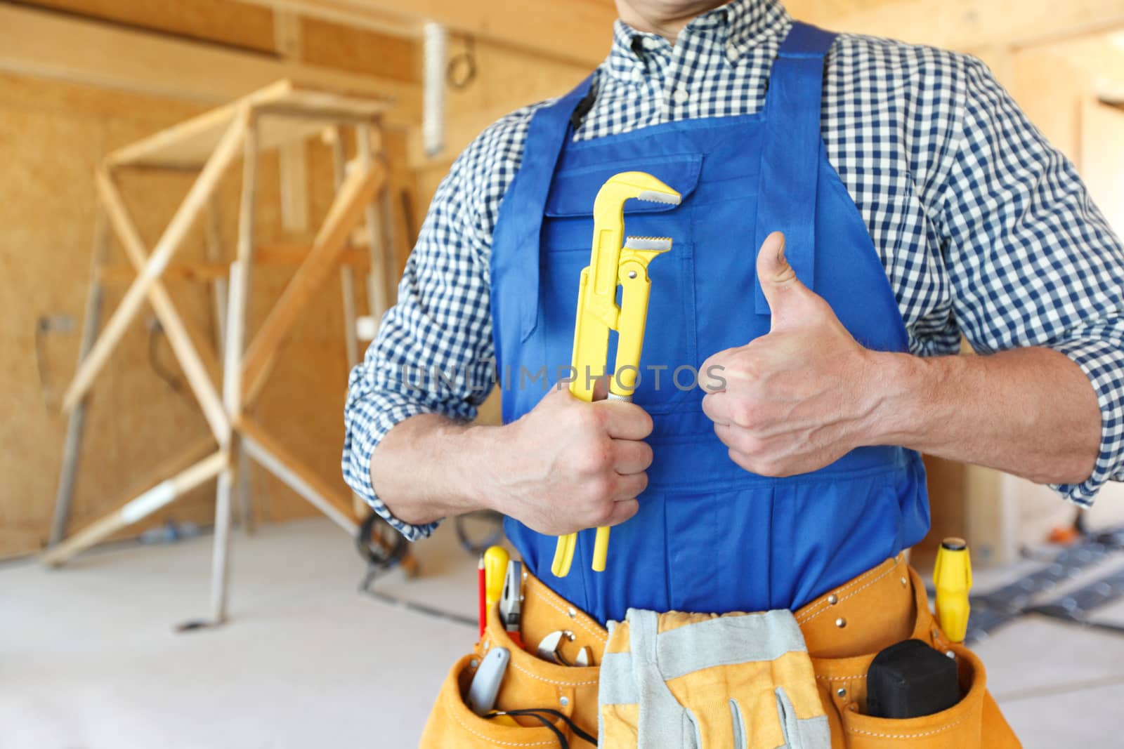 Worker with a monkey wrench at construcion site