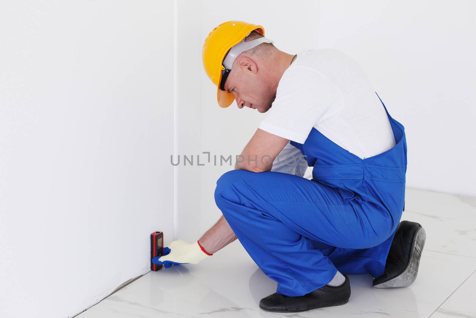 Worker using laser line level by ALotOfPeople