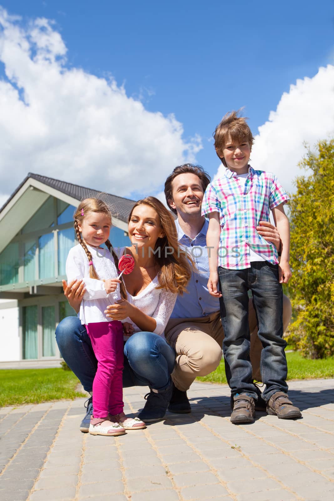 Happy family and their house by ALotOfPeople