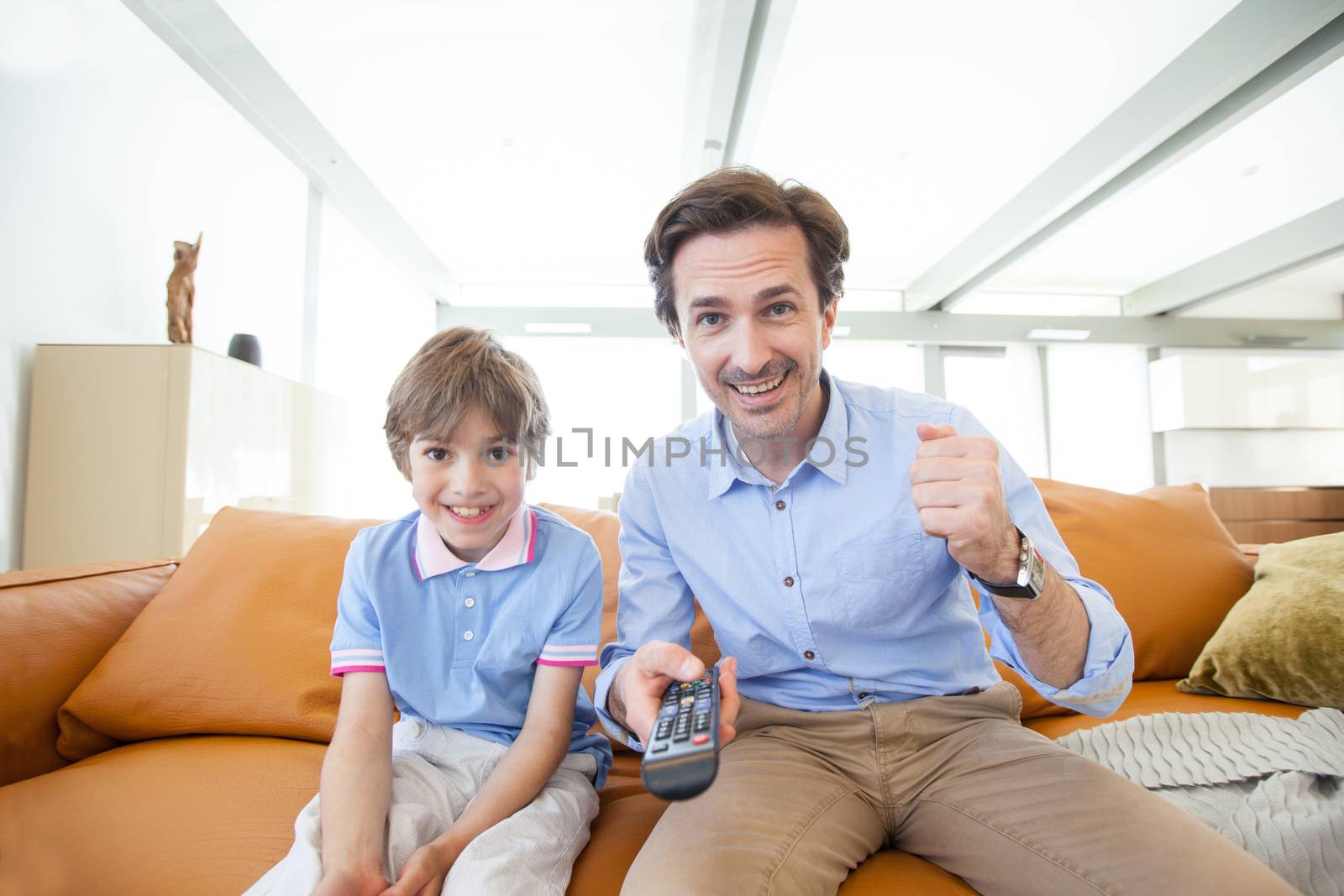 Father and son watching tv by ALotOfPeople