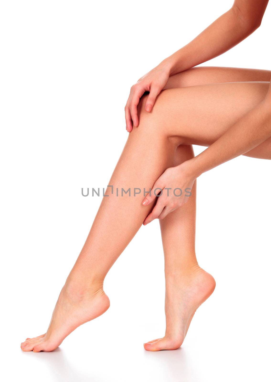 Beautiful long woman's legs and hands with smooth and soft skin isolated on white background
