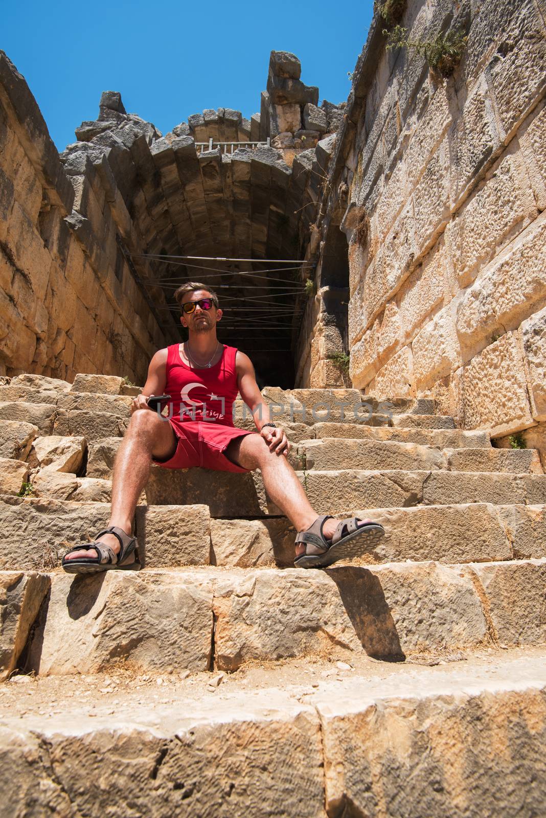 Young man at theatre in Myra ancient city of Antalya in Turkey.