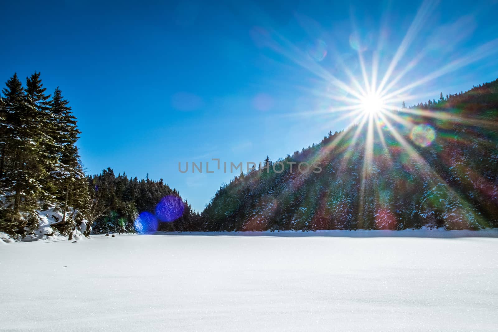 Frozen lake covered with snow landscape sun beam by fpalaticky