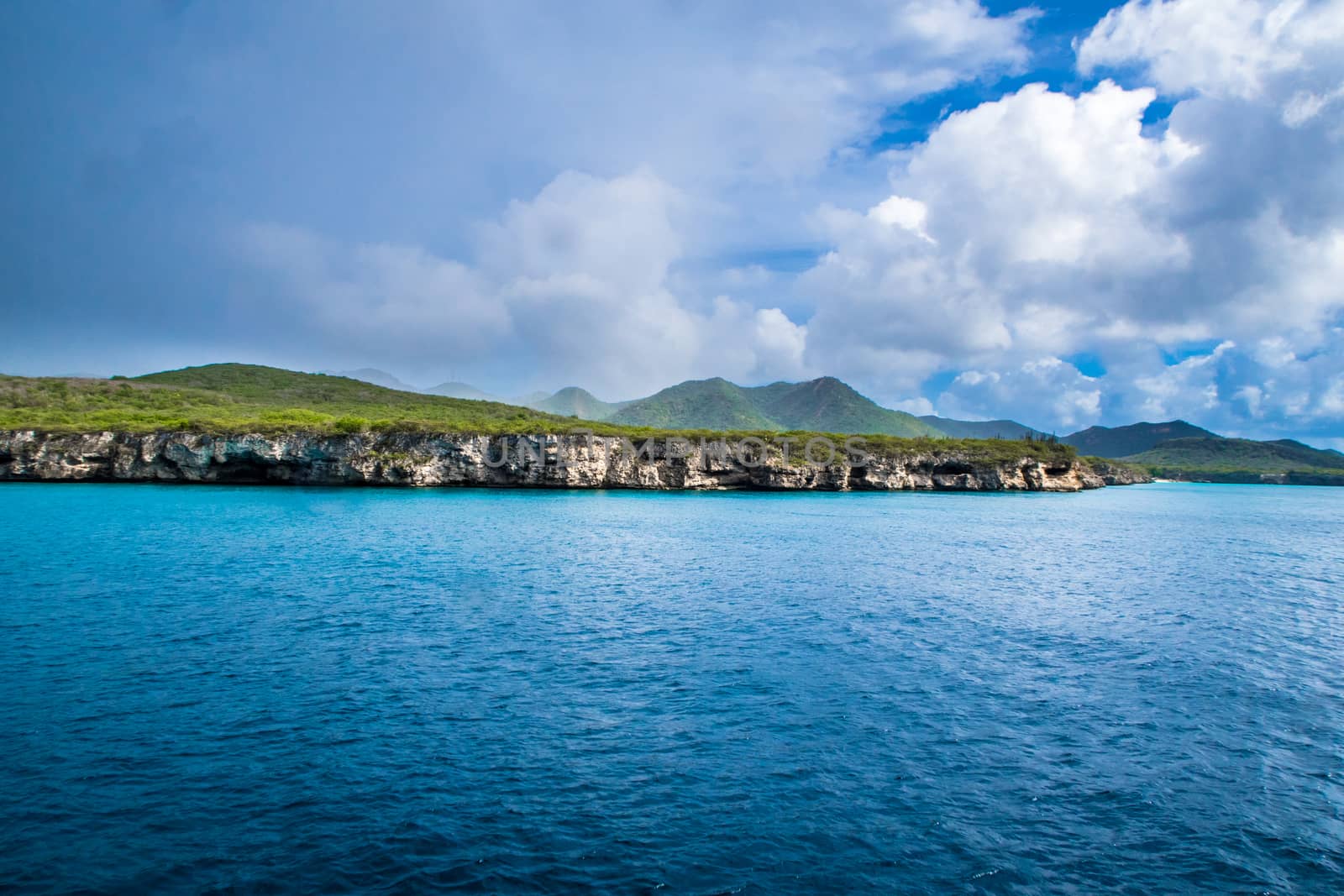 Stormy sky over island and ocean by fpalaticky