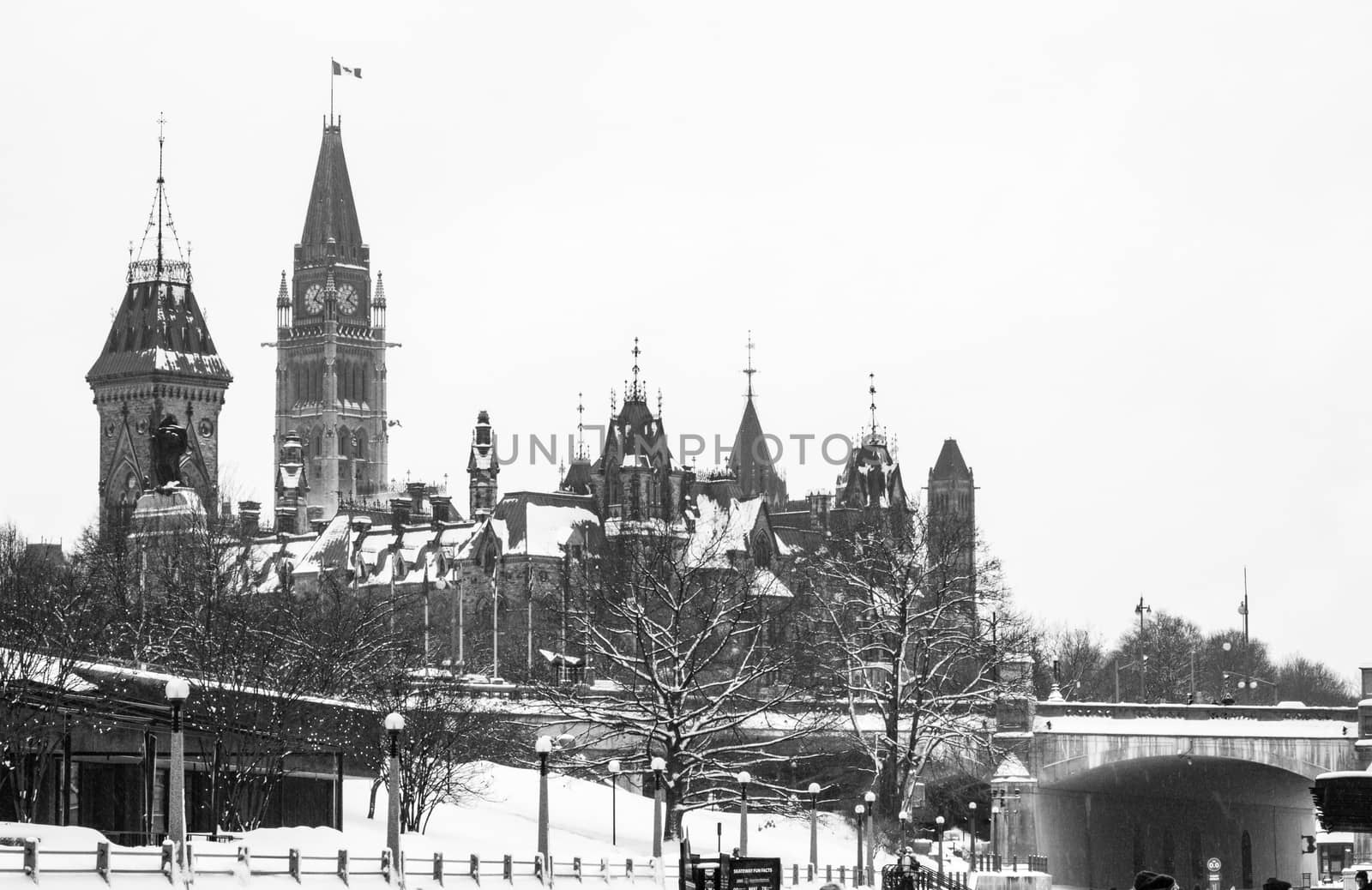 Black and white picture of the canadian parlement in ottawa with snow on the roof.