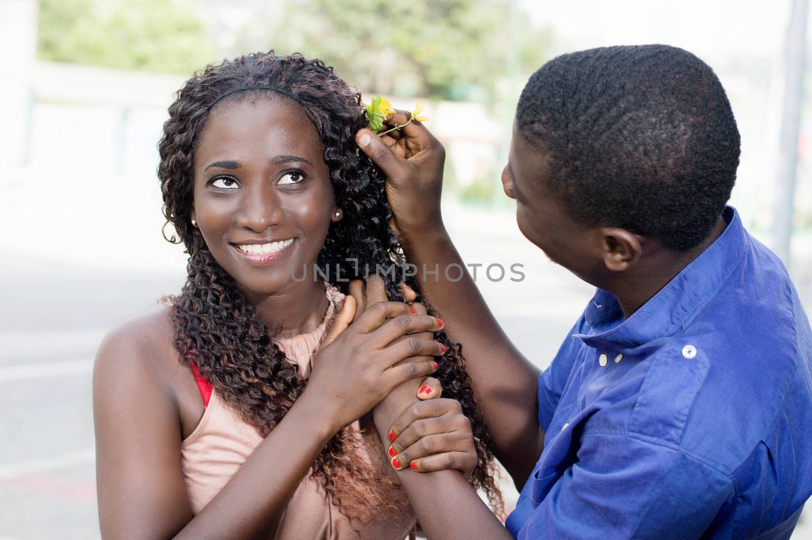 young woman is very happy to receive a flower from her companion.