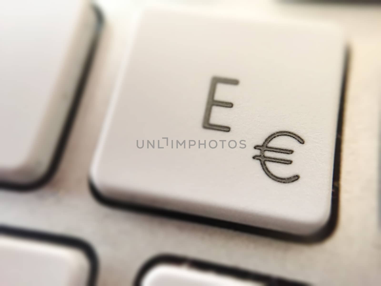 close-up view of of the button of a computer keyboard with the letter E and the symbol of the Euro coin