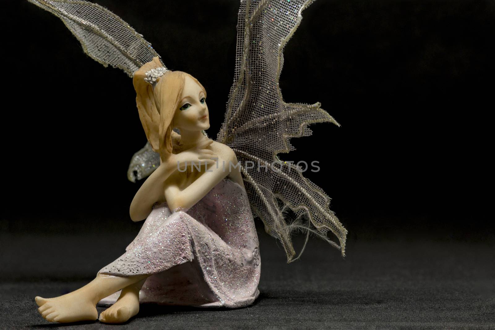 red hair fairy figurine while sitting