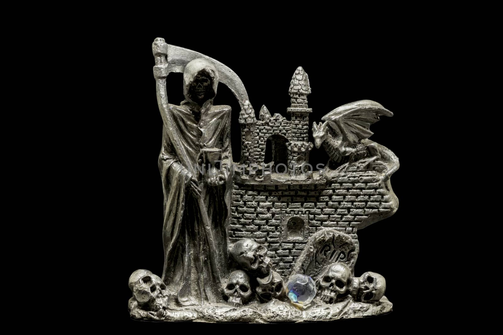 metal figurine of reaper with skulls