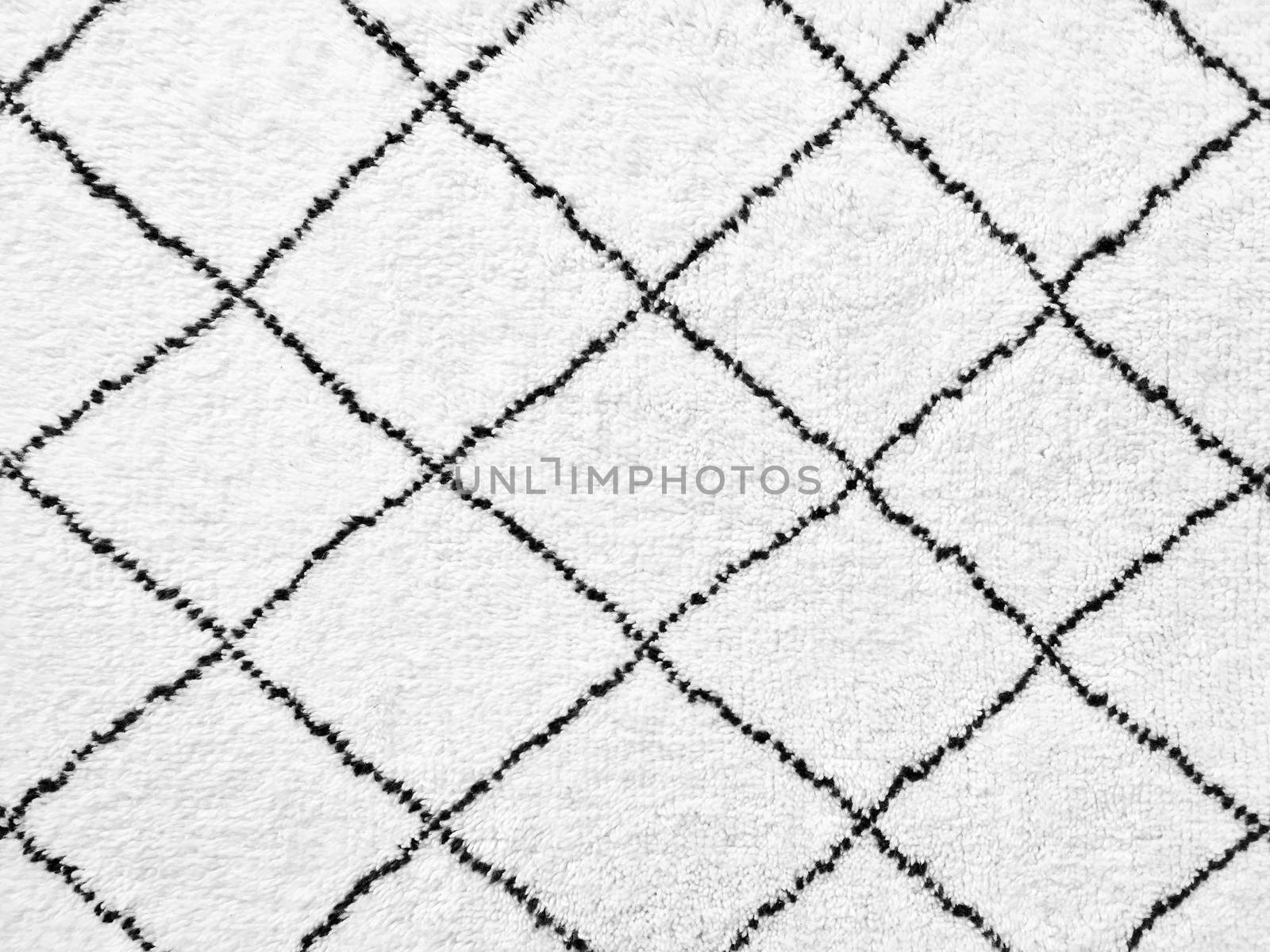 White rug with black lines. Simple geometric design.
