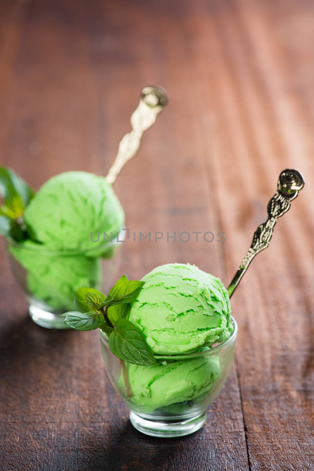 Mint ice cream in cup on dining table.