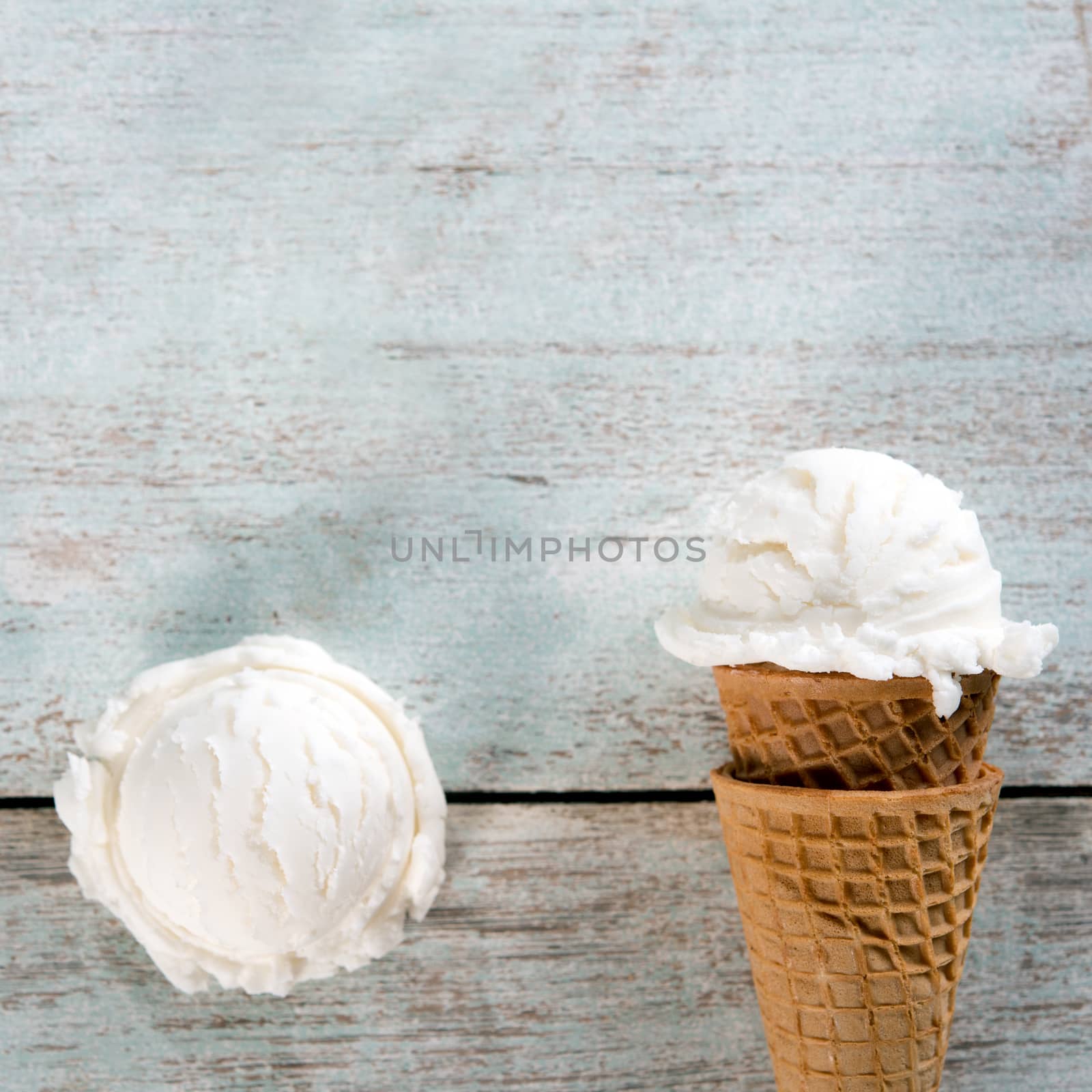Top view yogurt ice cream wafer cone on white rustic wooden background. Copy space on above.