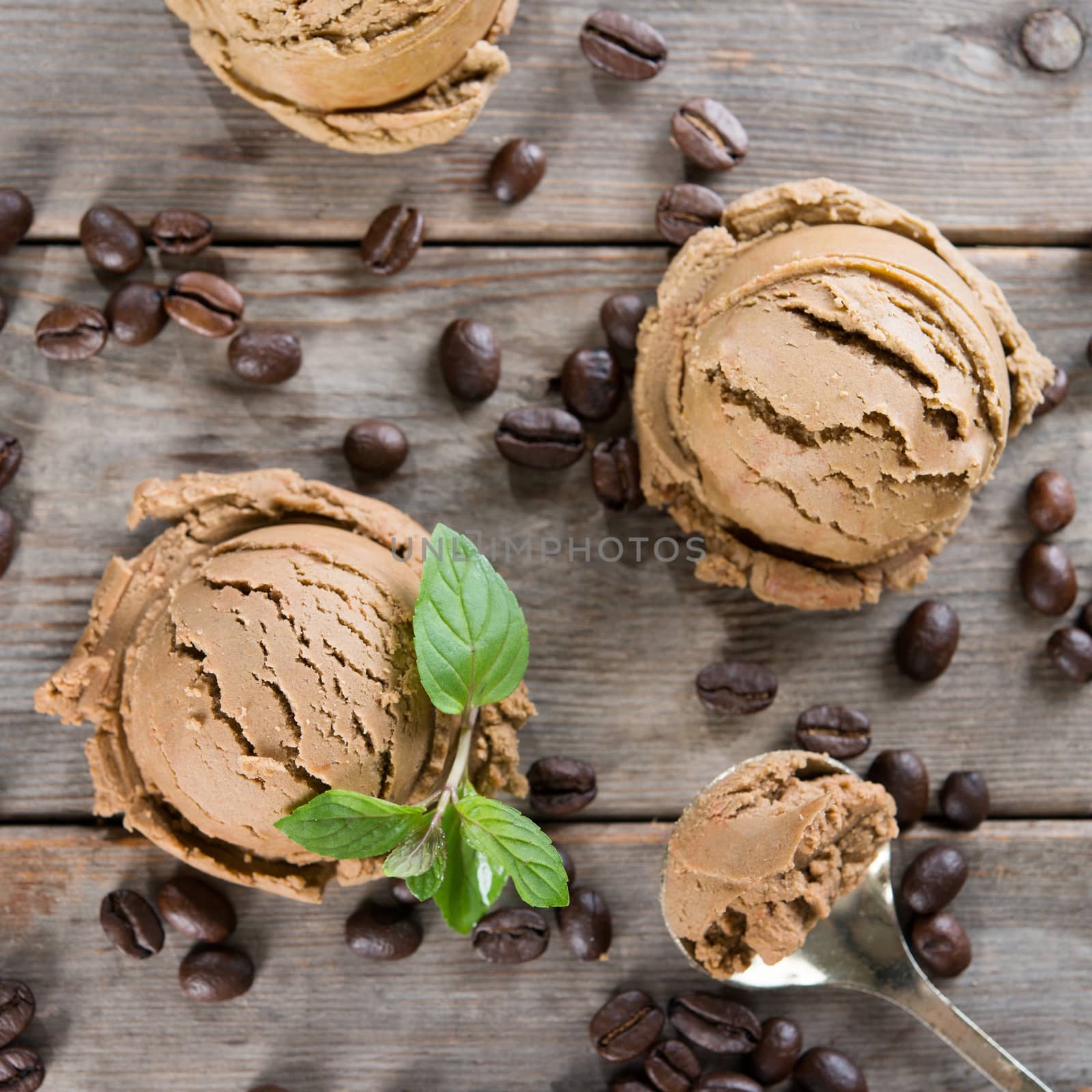 Top view brown ice cream and coffee beans on old rustic vintage wooden background.