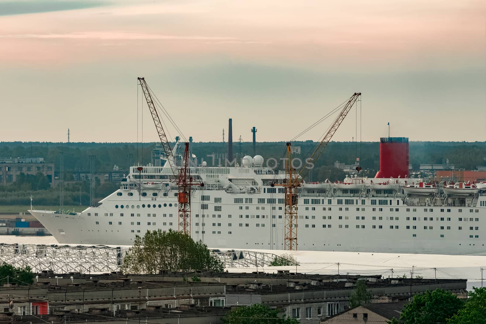 White passenger ship. Cruize ferry sailing past old town