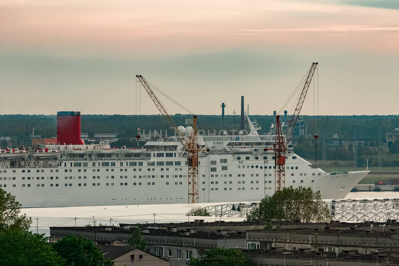 White passenger ship. Cruize ferry sailing past old town