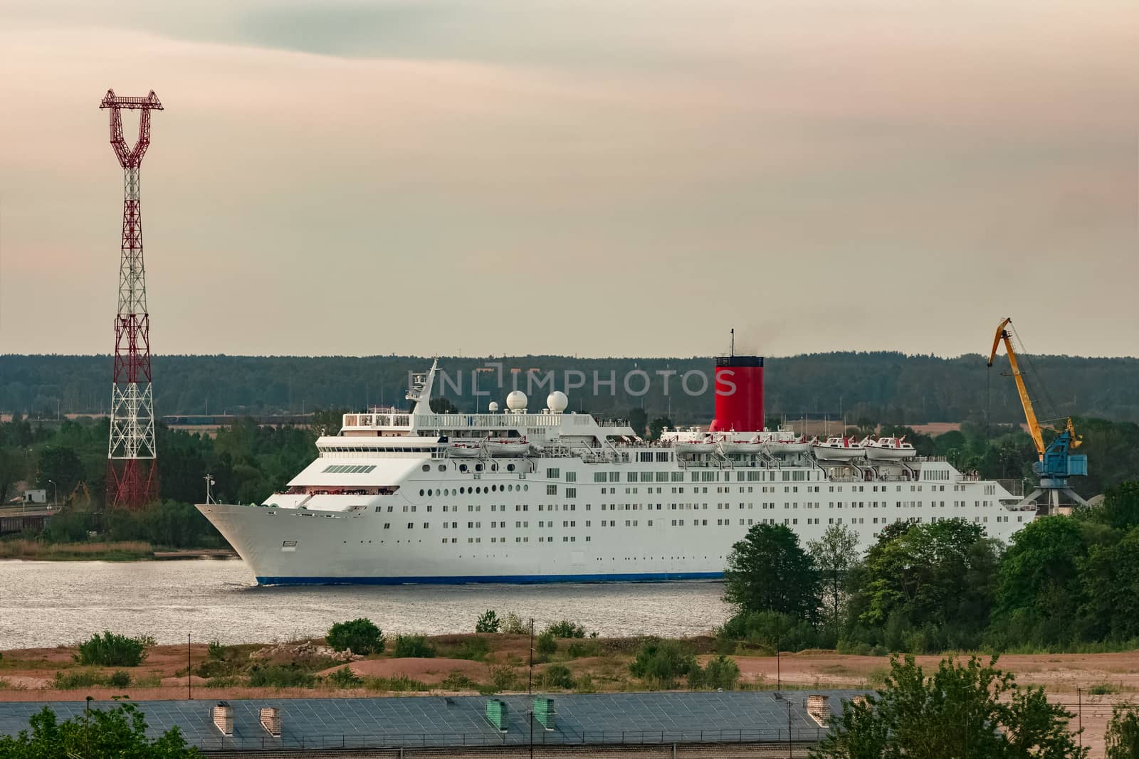White passenger ship. Cruize ferry sailing past old town