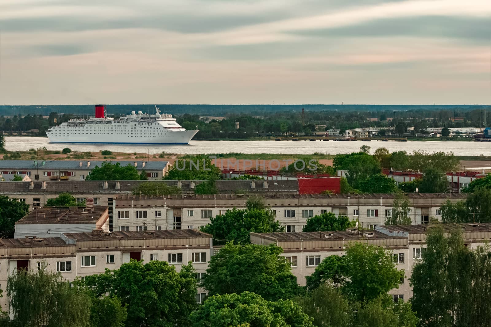 White passenger ship. Cruize ferry sailing past old town