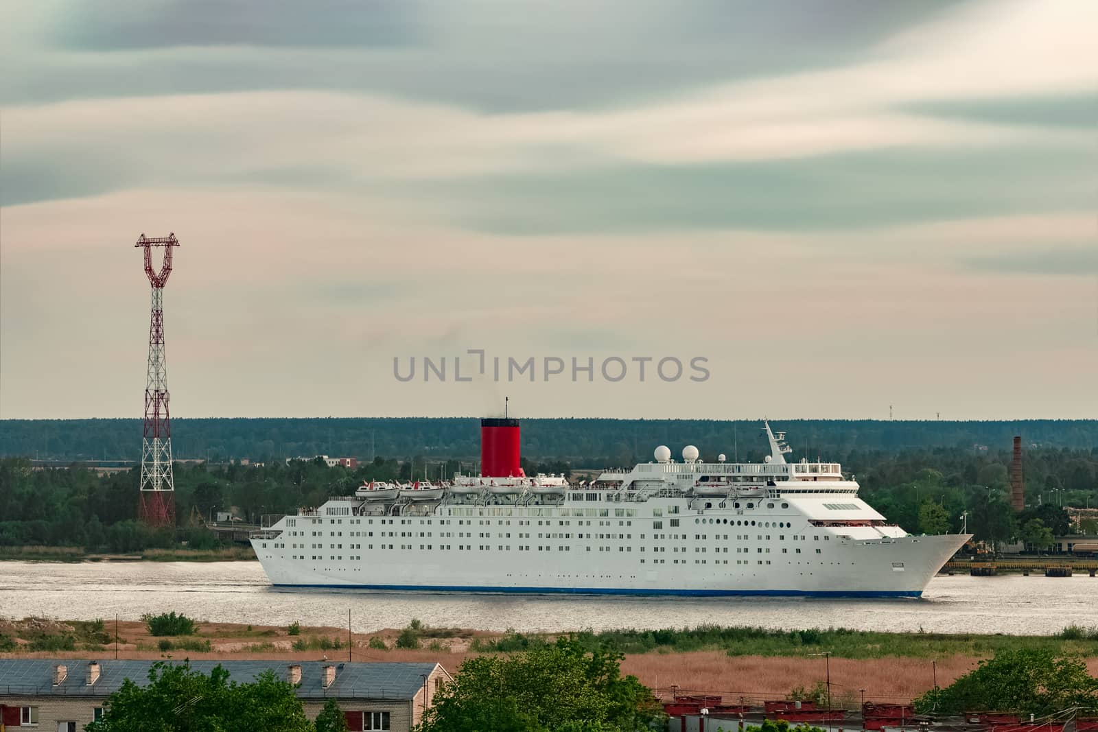White passenger ship. Cruize ferry sailing past old town