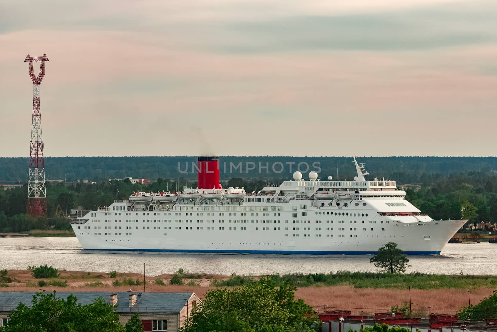 White passenger ship. Cruize ferry sailing past old town