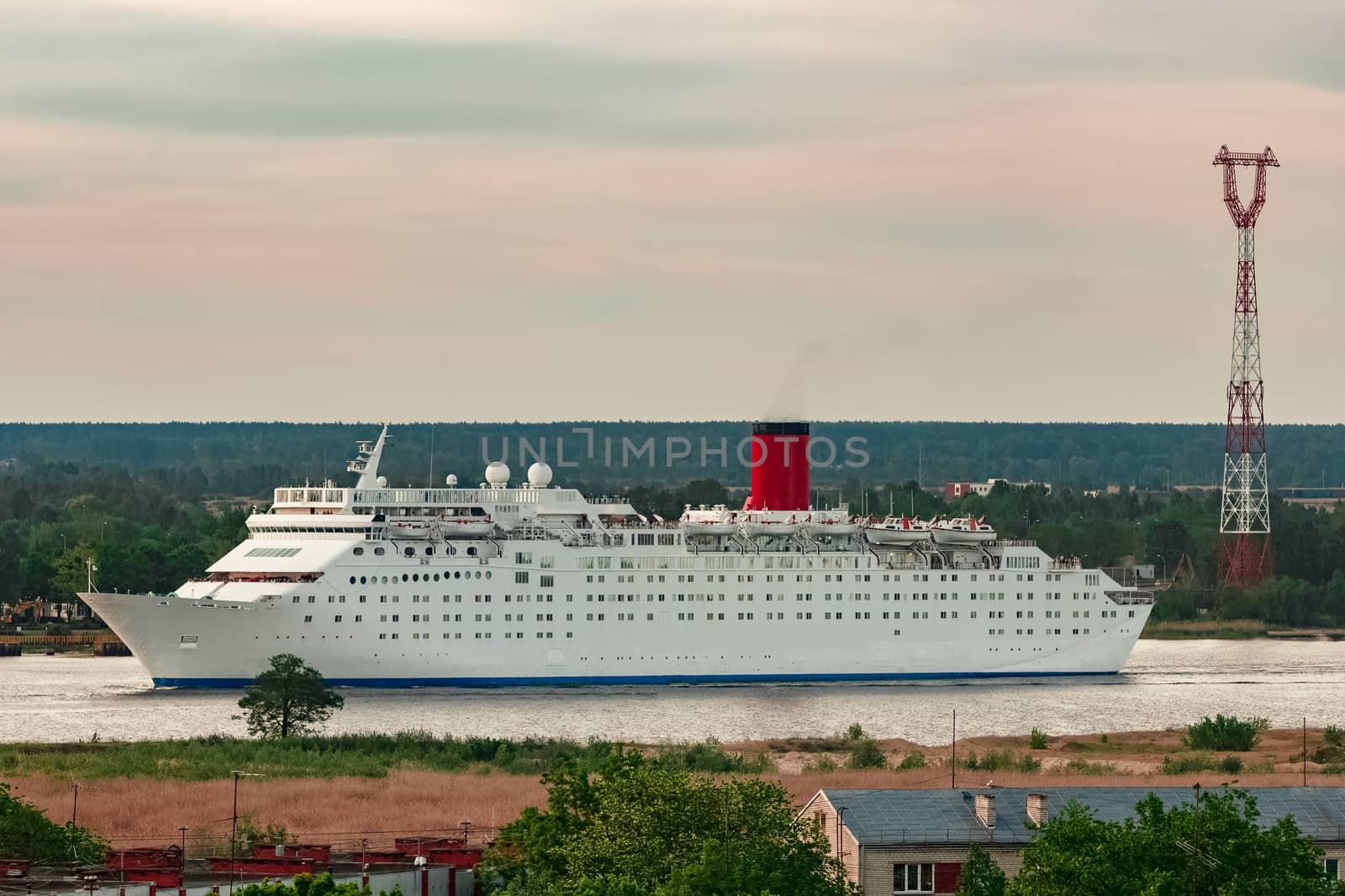 White passenger ship. Cruize ferry sailing past old town