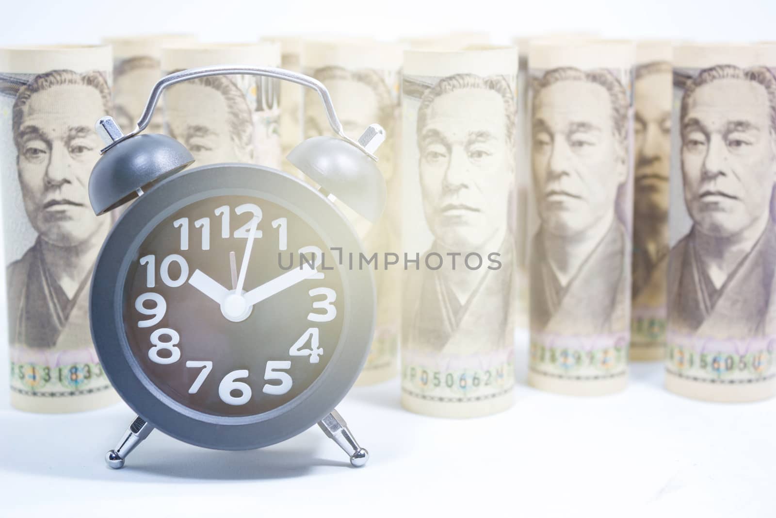 Classic Clock On Roll Of Yen Banknote, Concept And Idea Of Time Value And Money, Business And Finance Concepts, Money market in Asian