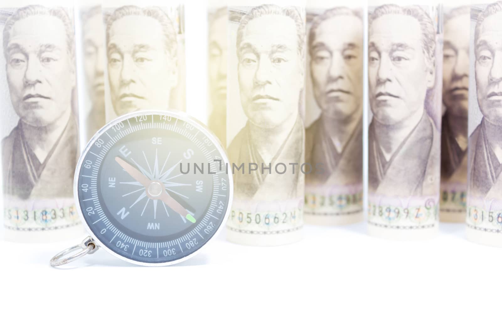 Compass On Roll Of Yen Banknote, Concept And Idea Of Direction A by rakoptonLPN