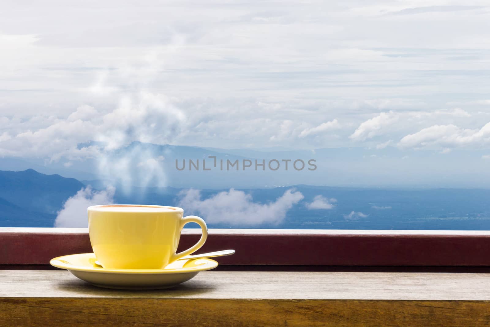 Coffee Mug On Wooden Top Table In Arial View Of Mountian. by rakoptonLPN