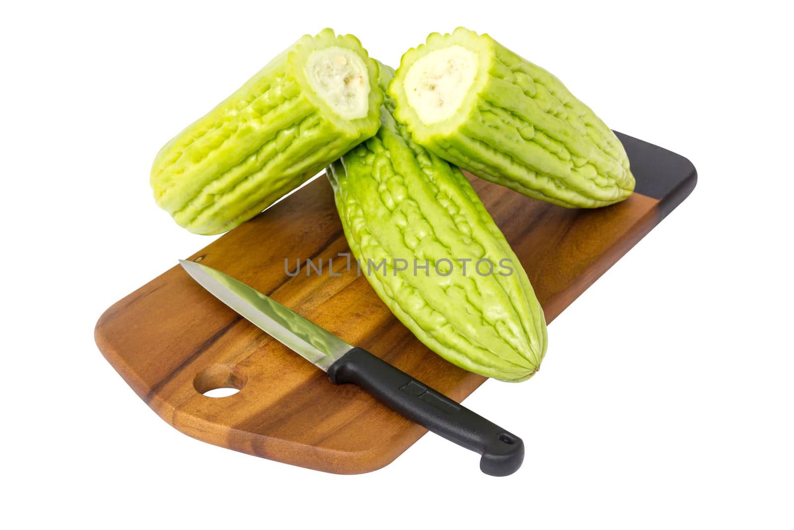 Fresh green bitter cucumber or chinese bitter melon on wooden plate isolated on white background