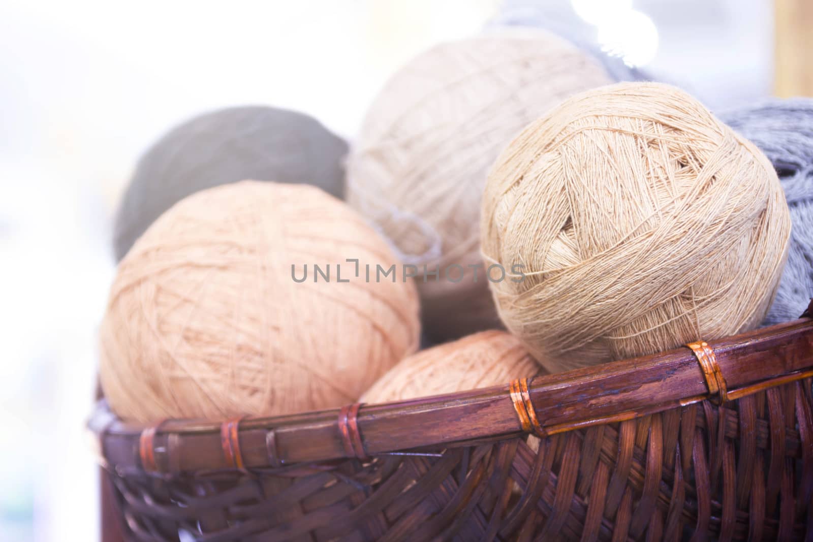 Balls Of Yarn In Basket, On Wooden Background And Copy Space. by rakoptonLPN