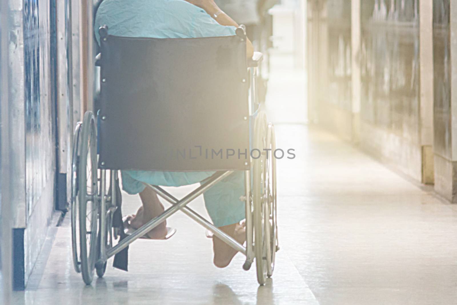 Abstract Of Man On Wheelchair In Front Of The Outpatient Department Of Hospital With Softlight.