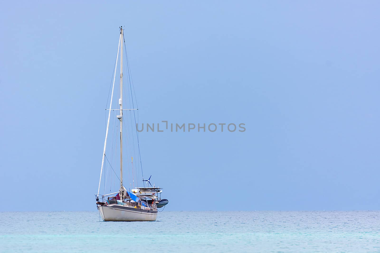 Alone Yacht Boat On Clear Blue Sea
