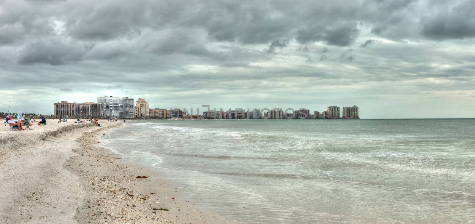 Buildings in the distance on Marco Island, Florida, beach under an overcast sky in winter