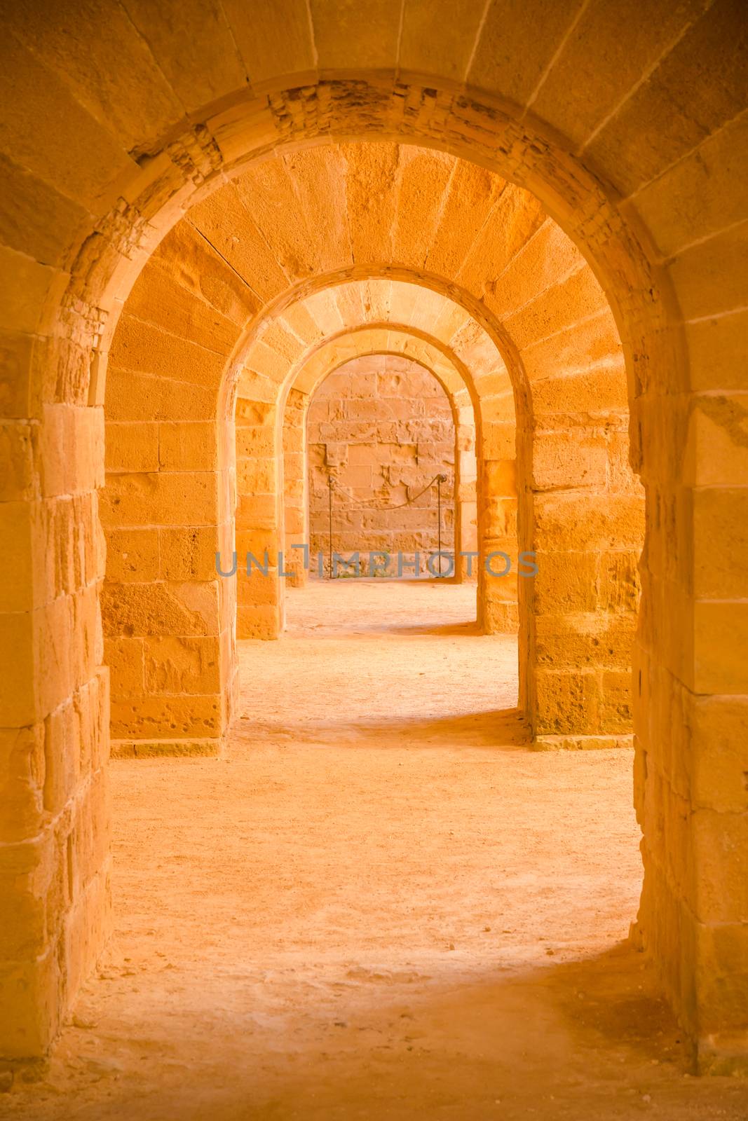 Italy - Old castle of Syracuse in Siciliy. Archs made of stone in perspective.