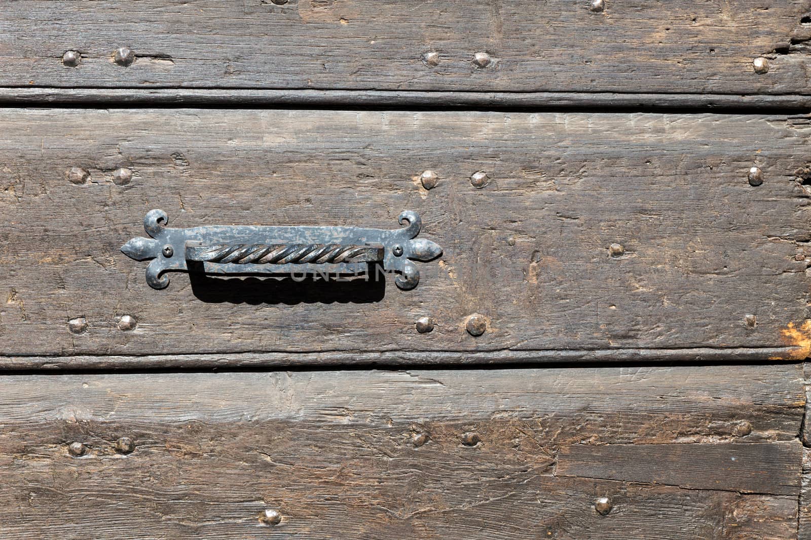 Close up of rustic old door in Spoleto, Italy.