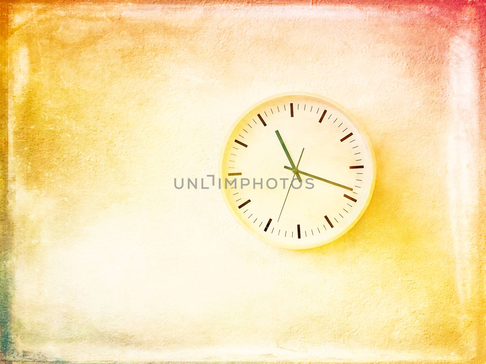 Modern round clock on bright and sunny painted wall. Artistic contemporary home decor.