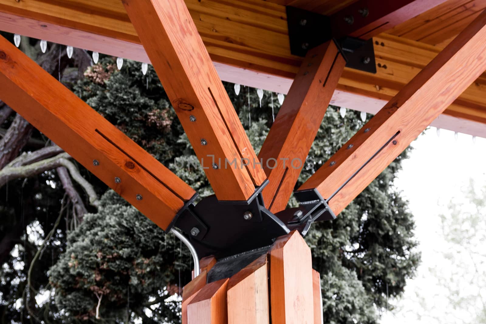 Orange angled outdoor roof support beams coming to a point