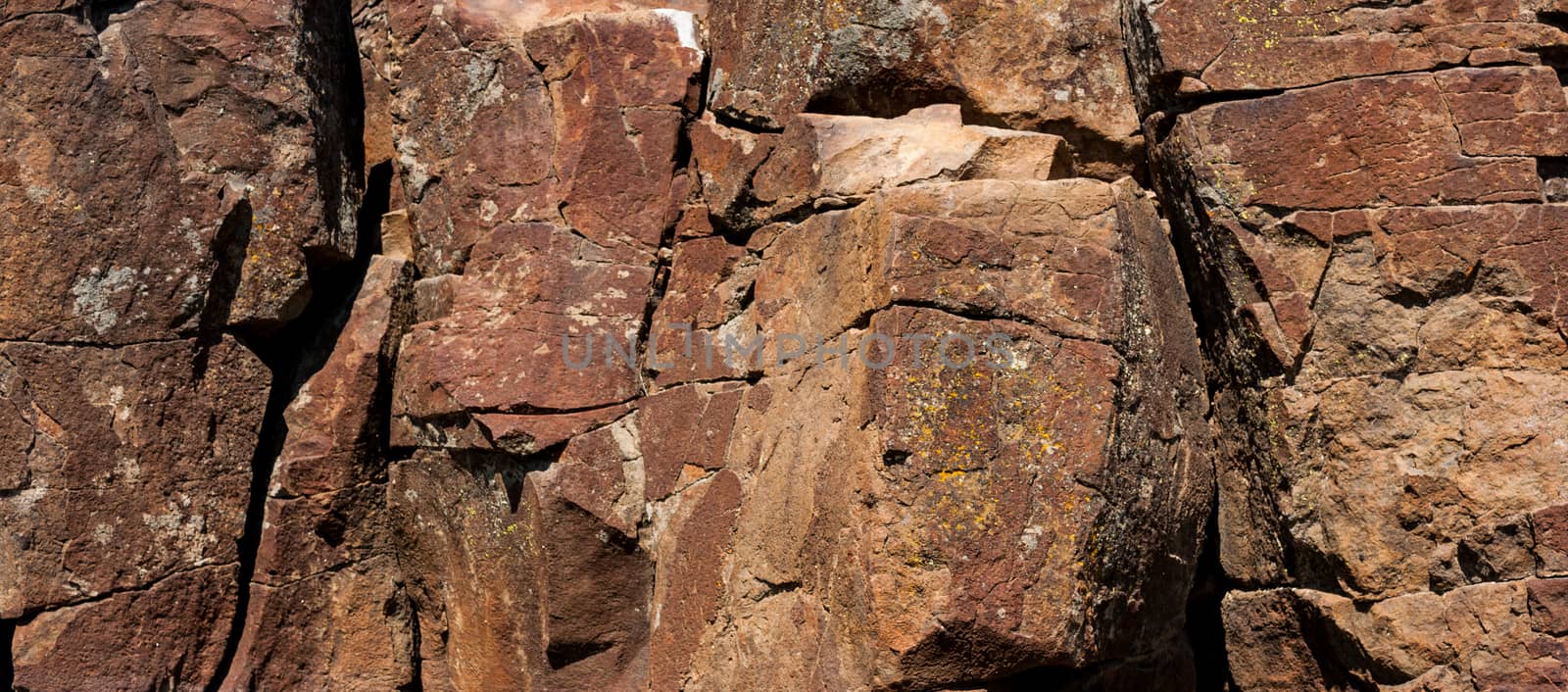 Red desert rocky hillside with rough cracked stones.