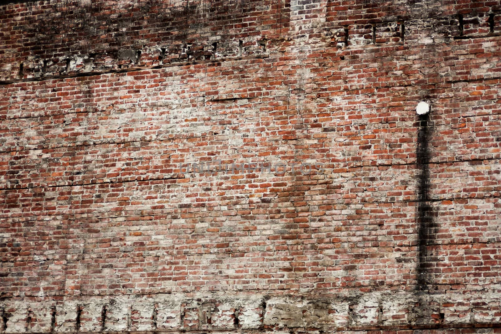 Old eroded stained brick wall background