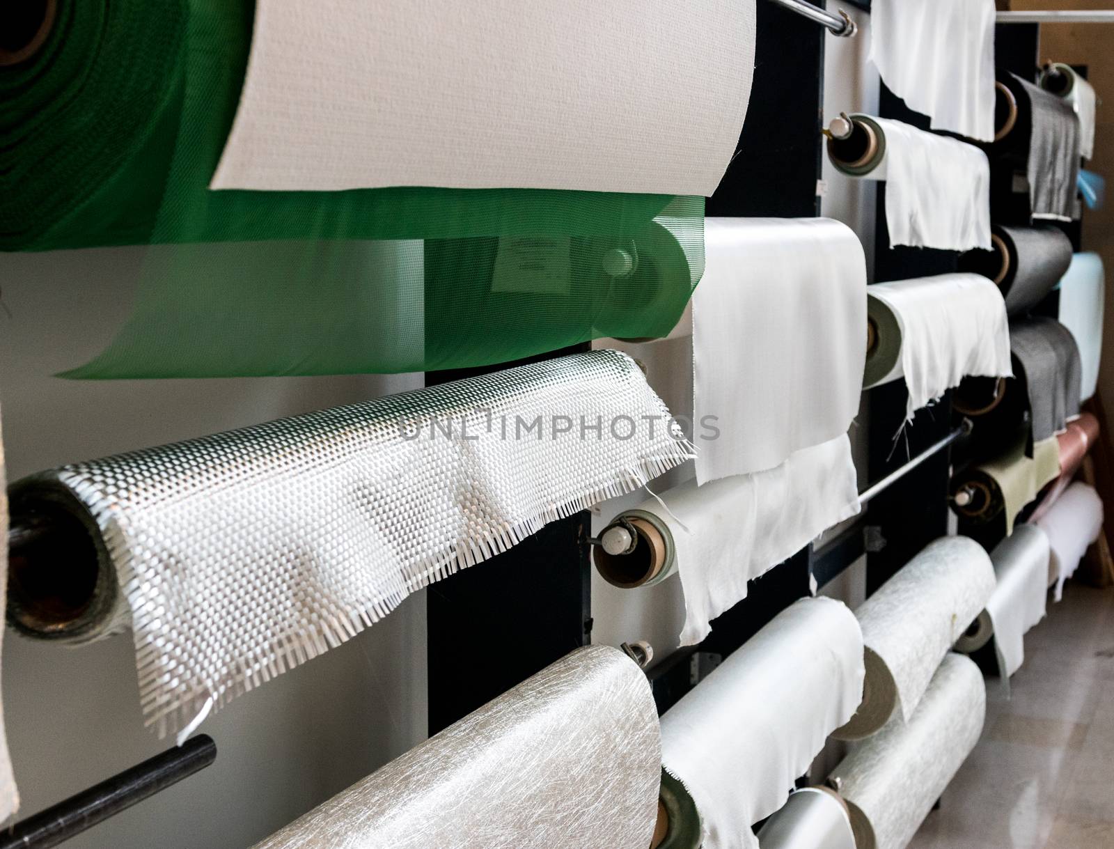 Fiberglass composite fabrics hanging on a wall dispenser