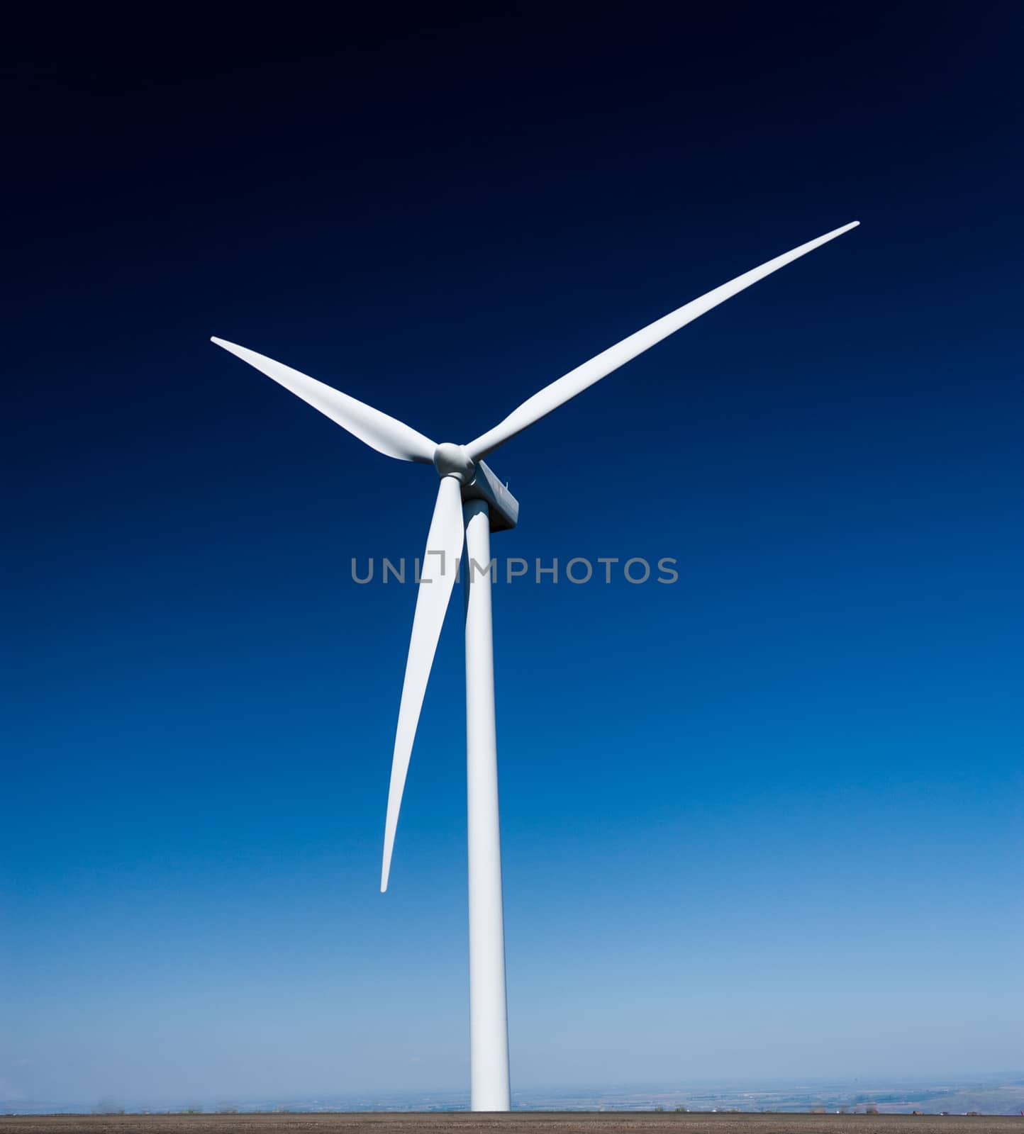 Power generating windmill with a deep blue sky by experiencesnw