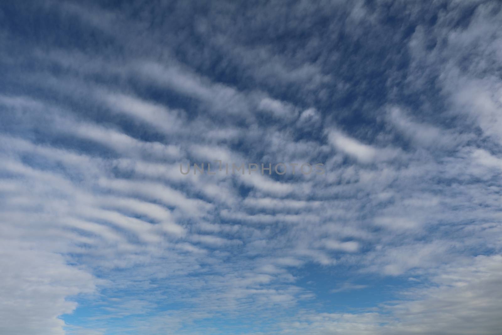 Altocumulous clouds show against the blue sky.