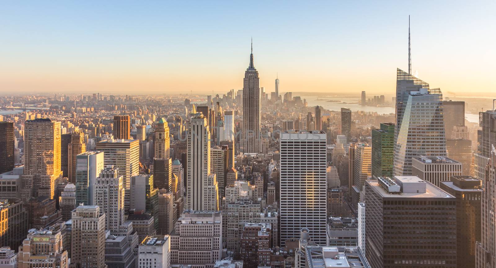 New York City. Manhattan downtown skyline with illuminated Empire State Building and skyscrapers at sunset. USA.