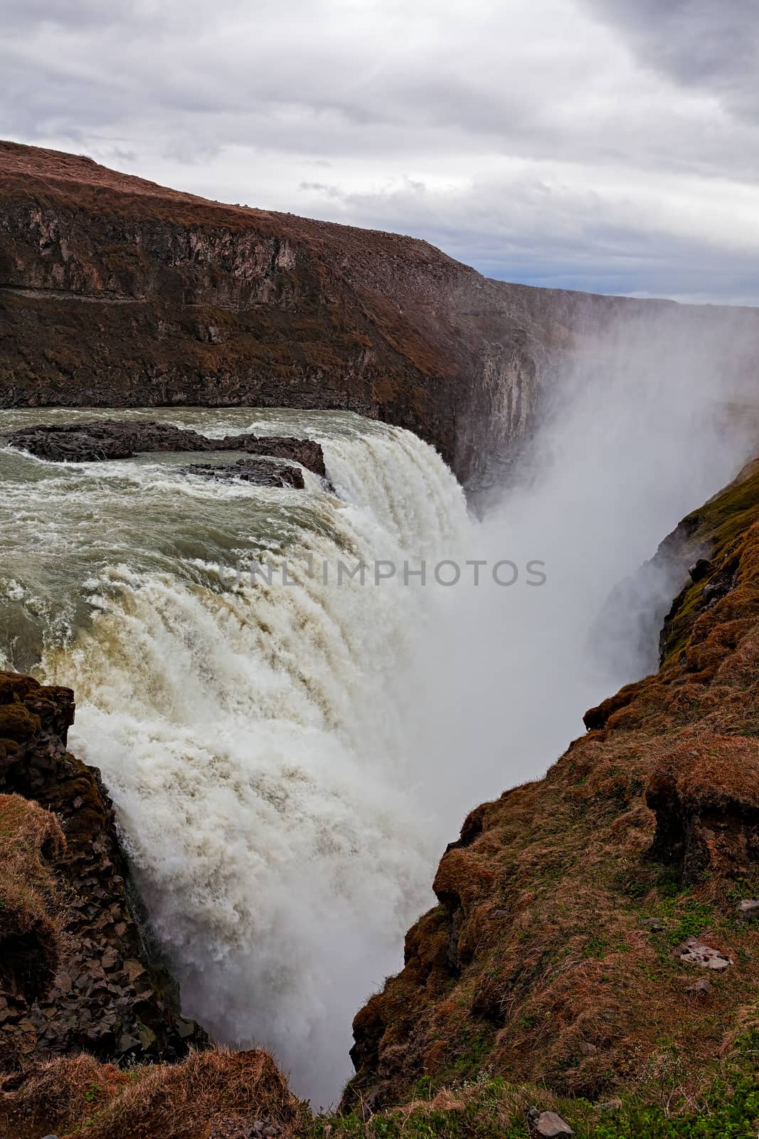 Powerful Gullfoss waterfall and its canyon in a cloudy day, Iceland