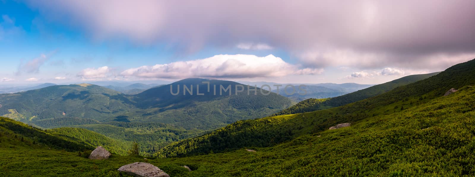 panorama of beautiful mountain landscape. beautiful scenery with clouds coming over the hills