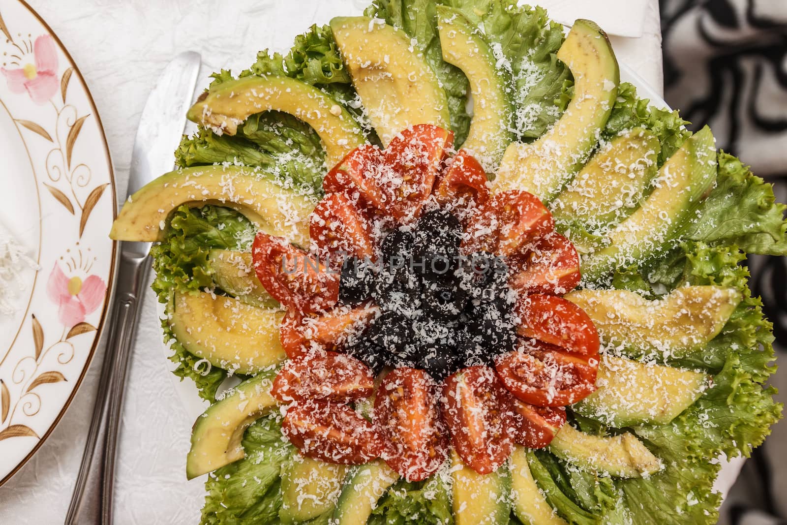 salad with avocado and tomato on a festive table by Tanacha