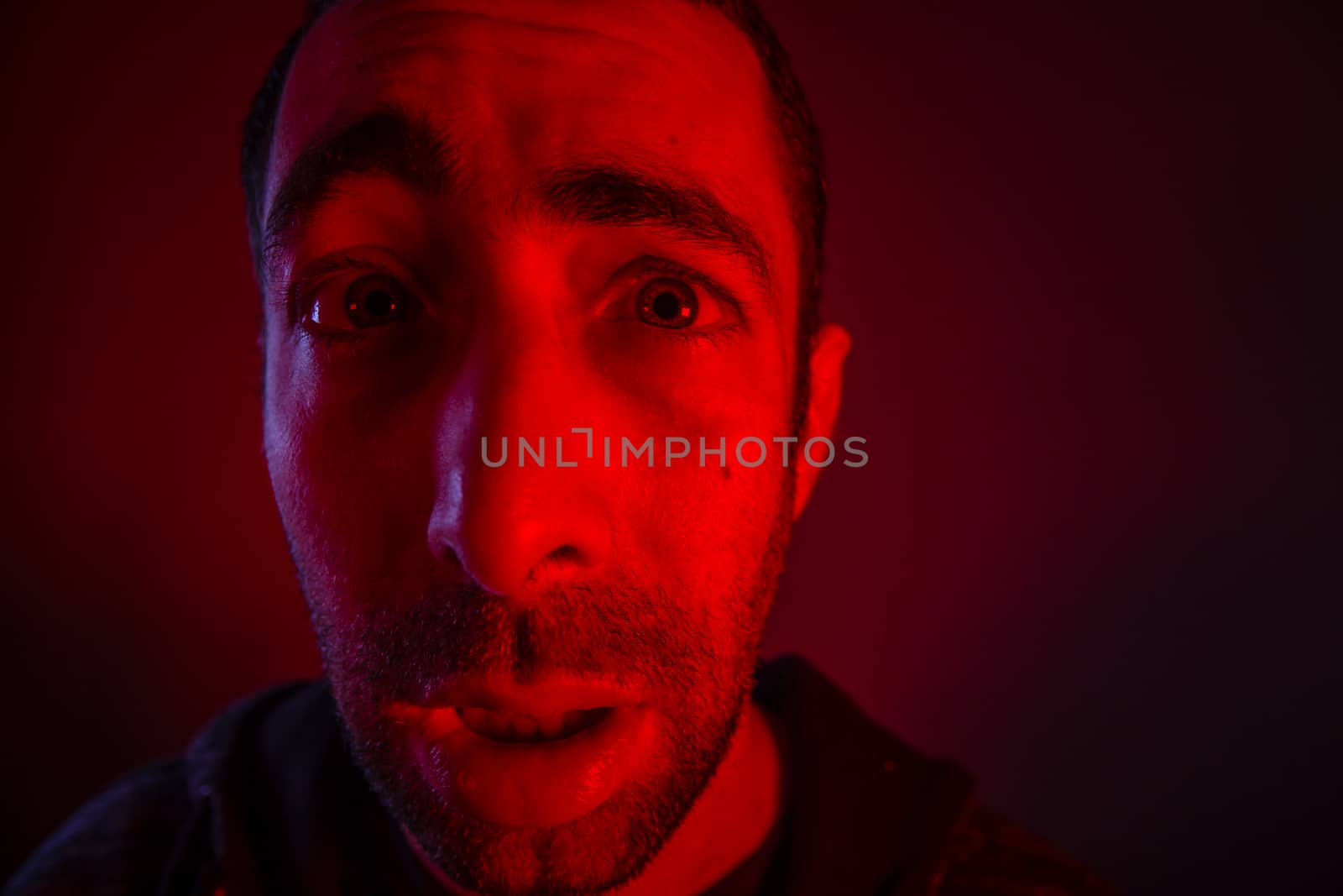 Man with surprised facial expression with opened mouth. Close up headshot portrait of shocked man

