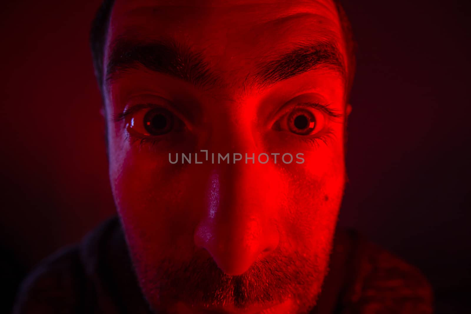 Man with surprised facial expression with opened mouth. Close up headshot portrait of shocked man
