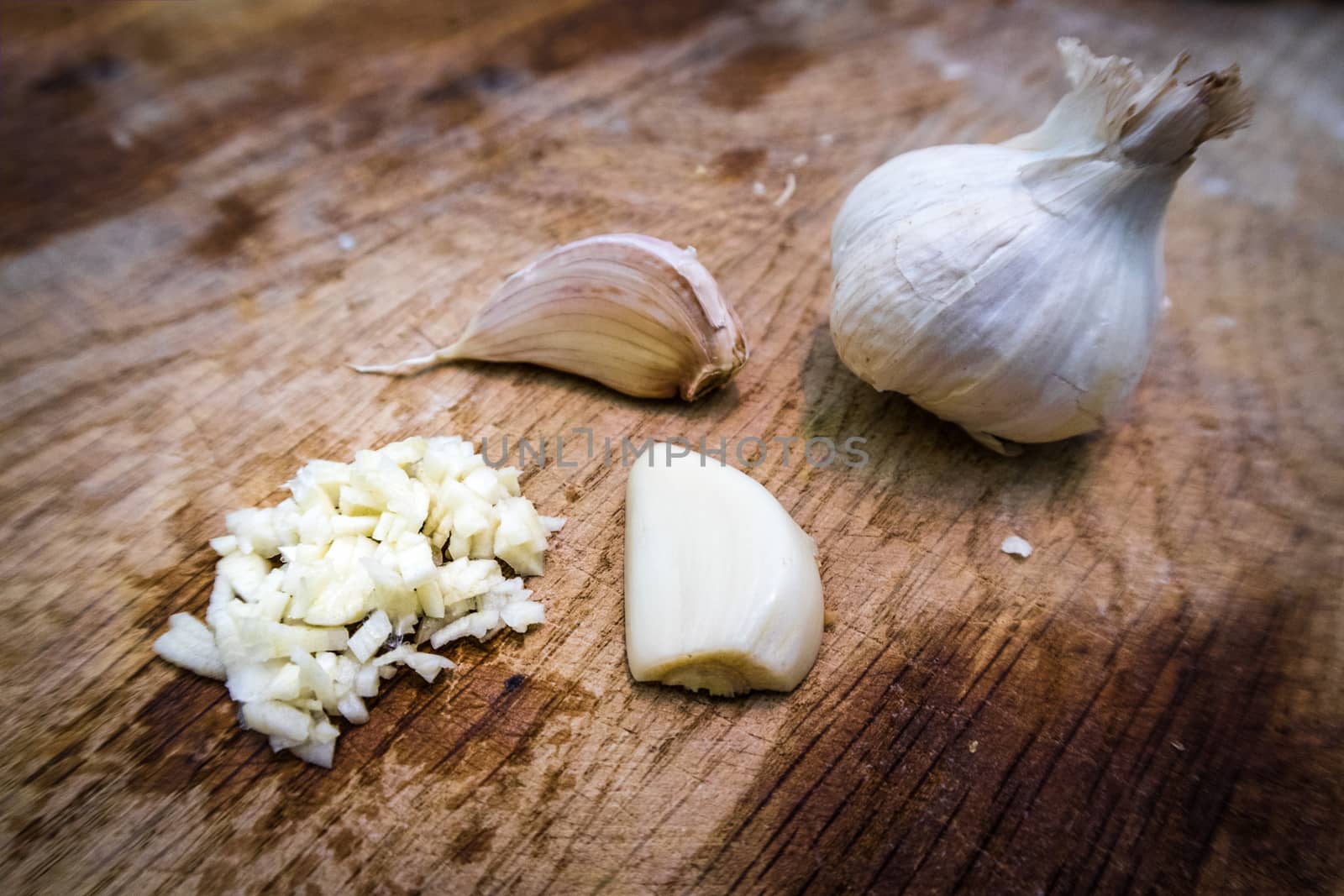 Garlic being chopped at different stage of the chopping process.